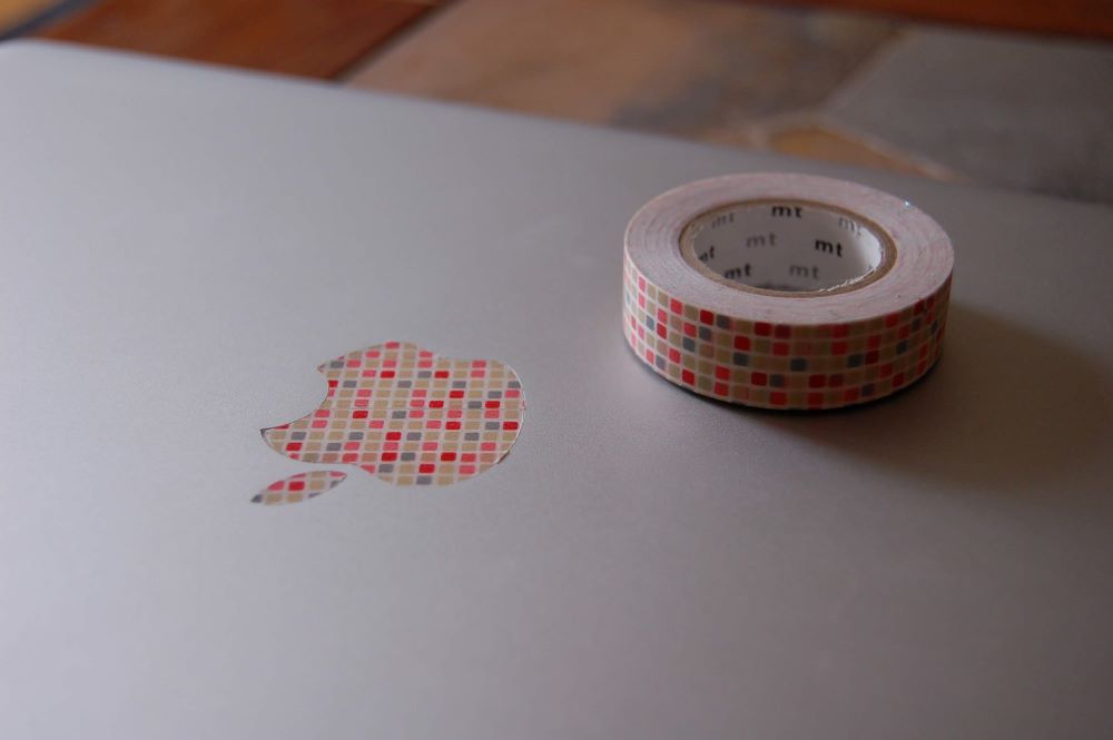roll of mt washi tape customizing apple logo mac laptop