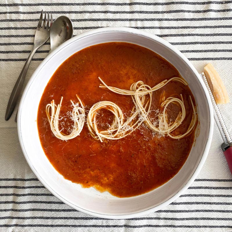 spaghetti in a bowl of red tomato sauce arranged to spell vote