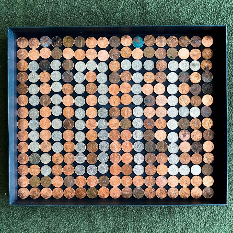 Pennies and dimes arranged into a grid that spells vote