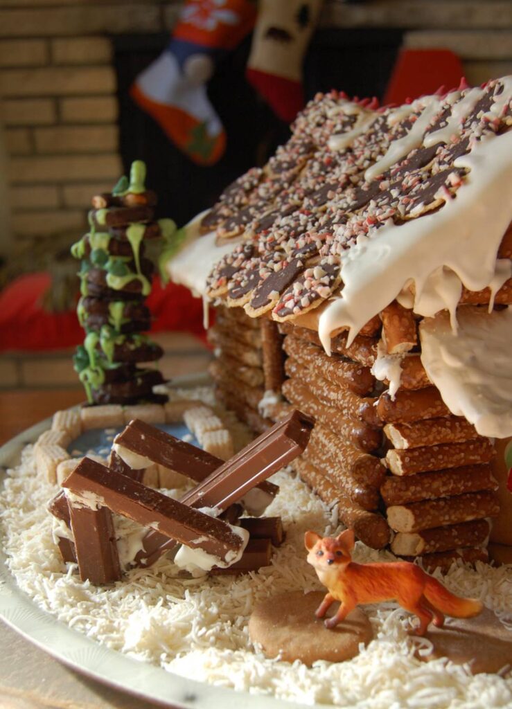 Kit Kat Adirondack Chair next to Log Cabin Gingerbread House