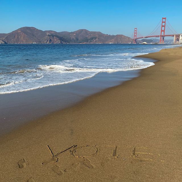 Vote in the sand at Baker Beach San Francisco with Golden Gate Bridge in background